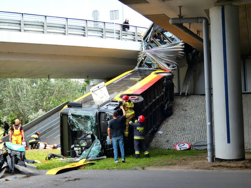 First responders attend to the scene of a public bus crash in Warsaw