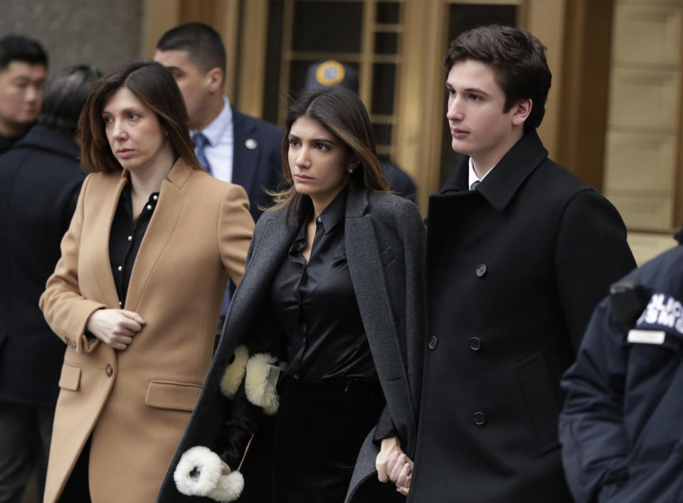 Laura Shusterman, left, leaves federal court after Michael Cohen, President Donald Trump's former lawyer, was sentenced, with children Samantha and Jake in New York, Wednesday, Dec. 12, 2018. Cohen was sentenced Wednesday to three years in prison for an array of crimes that included arranging the payment of hush money to two women that he says was done at the direction of Trump. (AP Photo/Julio Cortez)