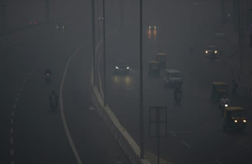 Commuters travel amid heavy smog in New Delhi after a night of free-for-all Diwali fireworks