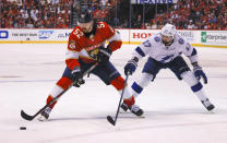 Florida Panthers defenseman MacKenzie Weegar (52) keeps the puck away from Tampa Bay Lightning left wing Alex Killorn (17) during the second period of Game 1 of an NHL hockey second-round playoff series Tuesday, May 17, 2022, in Sunrise, Fla. (AP Photo/Reinhold Matay)