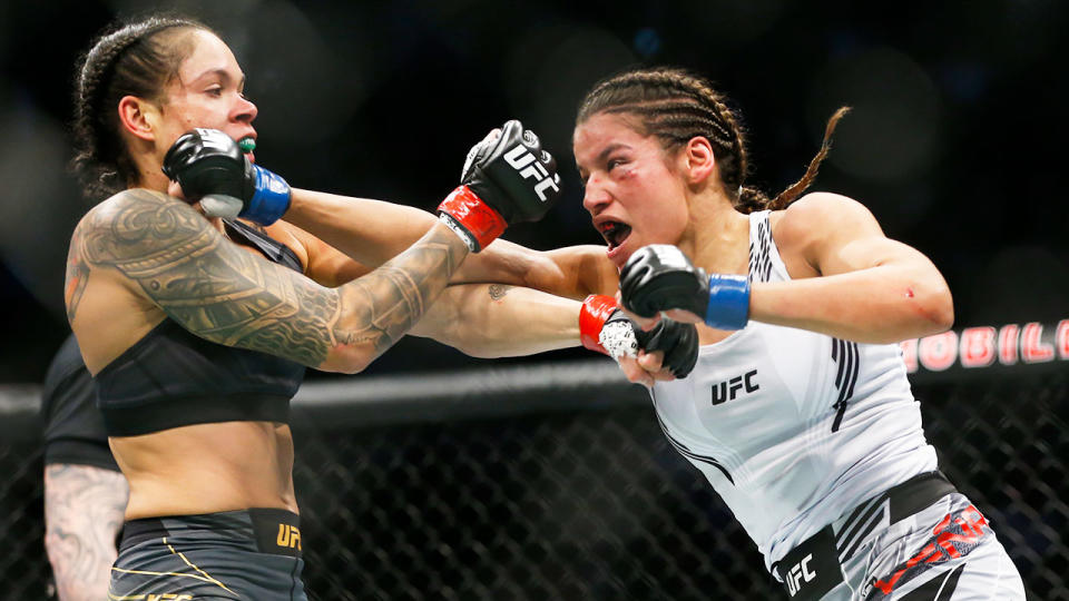 Pictured right, Julianna Peña aims a right hand at Amanda Nunes during their title fight at UFC 269.