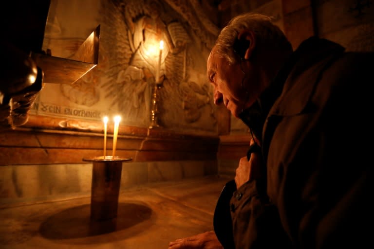 A Christian prays inside the edicule that surrounds the tomb where Jesus is believed to have been buried