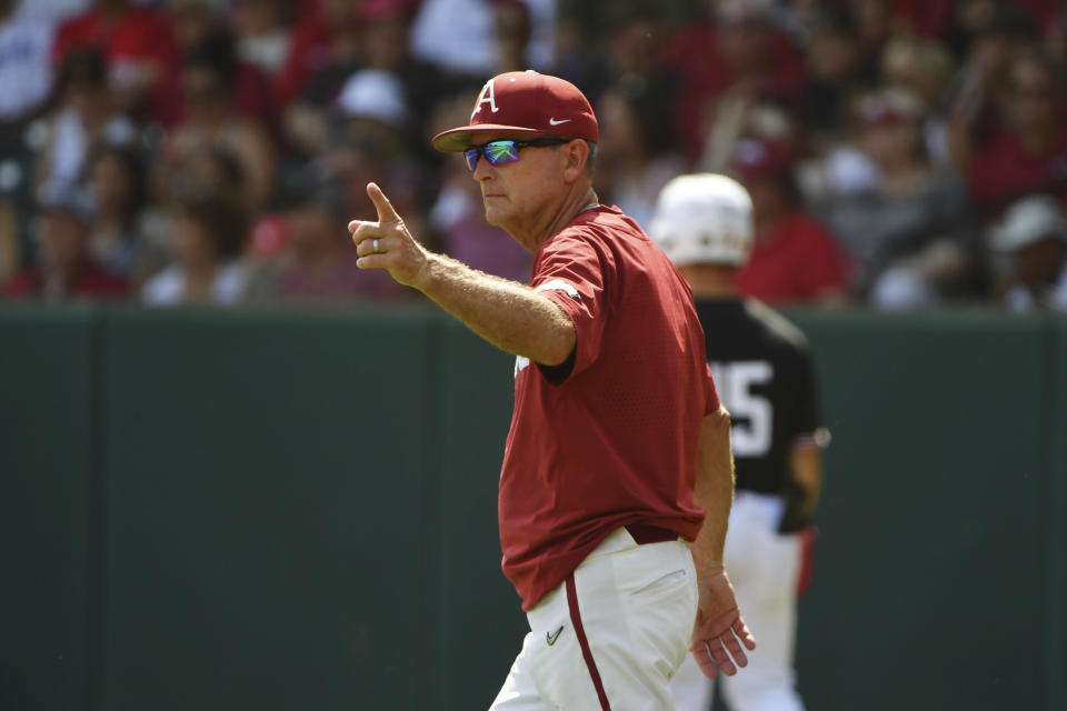 Arkansas coach Dave Van Horn heads to the mound to make a pitching change against North Carolina State in the fourth inning of an NCAA college baseball super regional game Saturday, June 12, 2021, in Fayetteville, Ark. (AP Photo/Michael Woods)