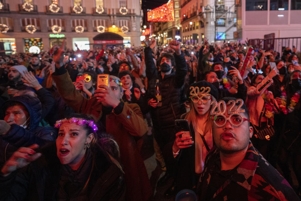 People celebrate during New Year's celebrations at Madrid's Puerta del Sol in downtown Madrid, Spain, early Saturday, Jan. 1, 2022. (AP Photo/Manu Fernandez)