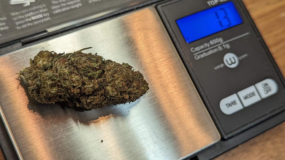 A bud of marijuana on a scale.