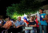 A woman holds the Russian flag as she watches the World Cup 2018 match between Egypt and Russia, in Damascus, Syria June 19, 2018. Picture taken June 19, 2018. REUTERS/Omar Sanadiki