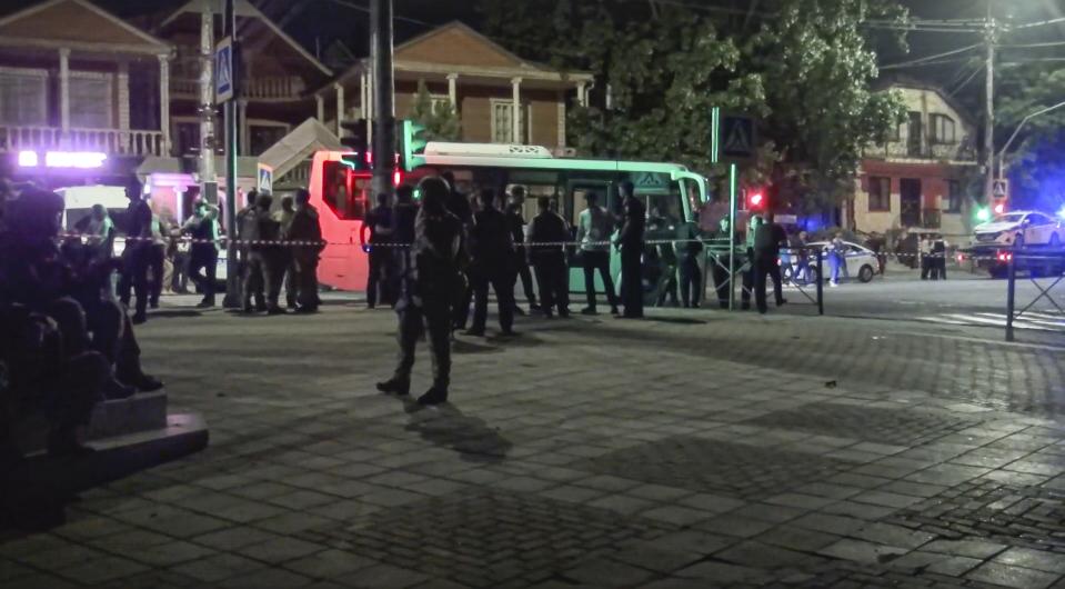 In this photo taken from video released by the National Antiterrorism Committee on Monday, June 24, 2024, Police and FSB officers gather as they conduct a counter-terrorist operation in republic of Dagestan, Russia. Multiple police officers and several civilians, including an Orthodox priest, were killed by armed militants in Russia's southern republic of Dagestan on Sunday, its governor Sergei Melikov said in a video statement early Monday. (The National Antiterrorism Committee via AP)