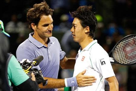 Mar 26, 2014; Miami, FL, USA; Kei Nishikori (R) shakes hands with Roger Federer (L) after their match on day ten of the Sony Open at Crandon Tennis Center. Nishikori won 3-6, 7-5, 6-4. Mandatory Credit: Geoff Burke-USA