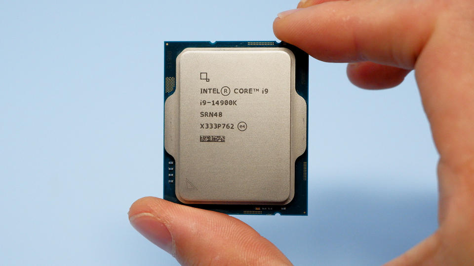 Intel Core i9 14900K CPU on a box and inside a motherboard socket.