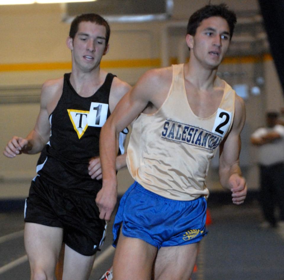 Dominic Della Pelle, Salesianum (right), turns the corner while running in the 1600 meters in the Field House at the University of Delaware in Newark Saturday Feb. 17, 2007.