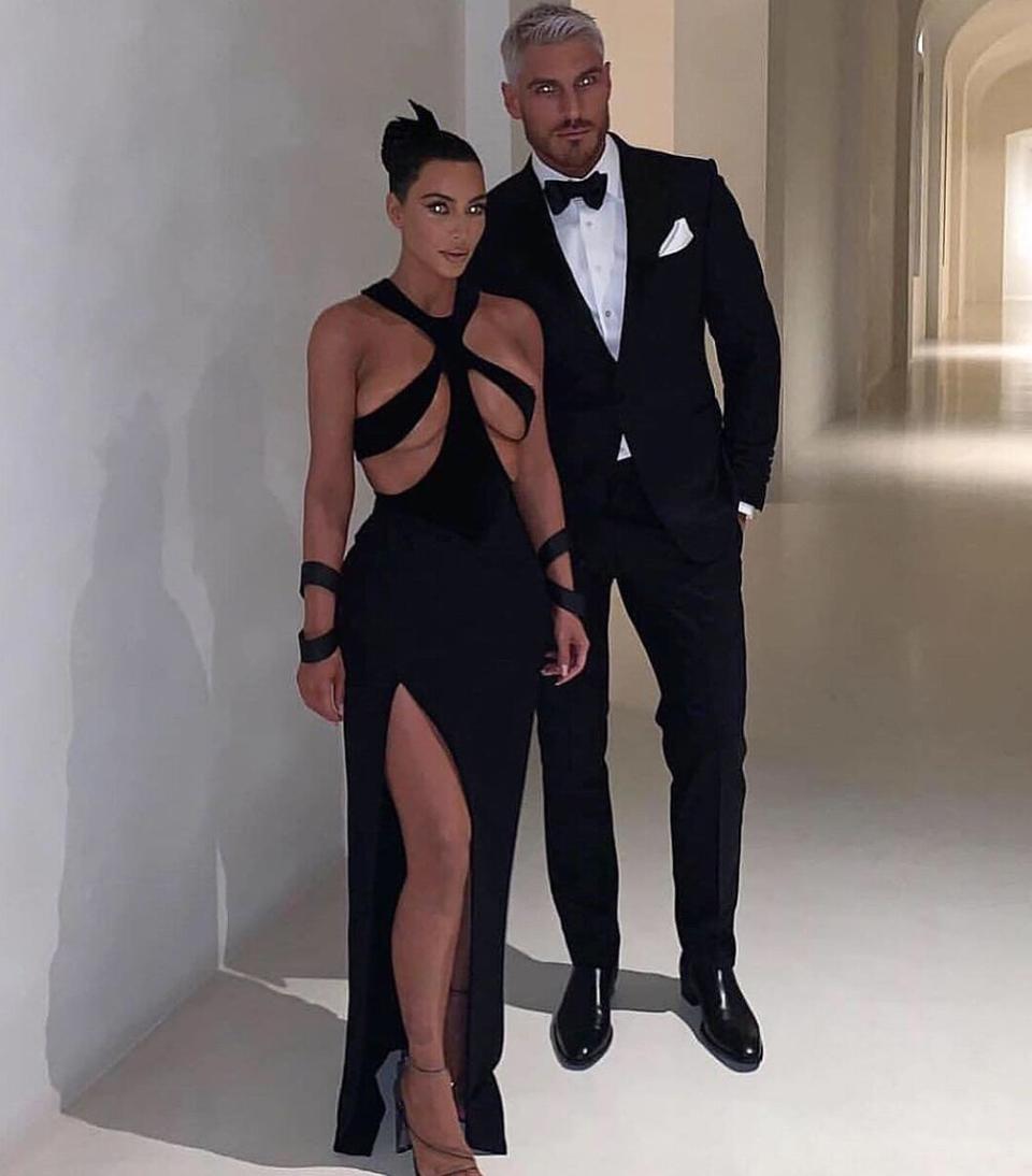 Kim posed in a <a href="https://people.com/style/kim-kardashian-wears-sexiest-dress-ever/" rel="nofollow noopener" target="_blank" data-ylk="slk:bust-baring black dress;elm:context_link;itc:0;sec:content-canvas" class="link ">bust-baring black dress</a> with her hair stylist Chris Appleton on the night he won a Hollywood Beauty Award in the same portrait-worthy white hallway. Appleton posted the same photo captioned, "Prom night." 