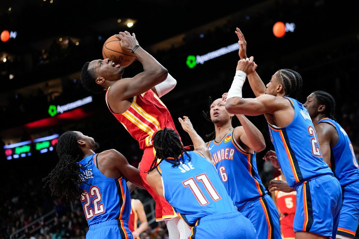 Atlanta Hawks forward Onyeka Okongwu (17) is surrounded by Oklahoma City Thunder players as he goes in for a shot during the first half of an NBA basketball game Wednesday, Jan. 3, 2024, in Atlanta. (AP Photo/John Bazemore)y