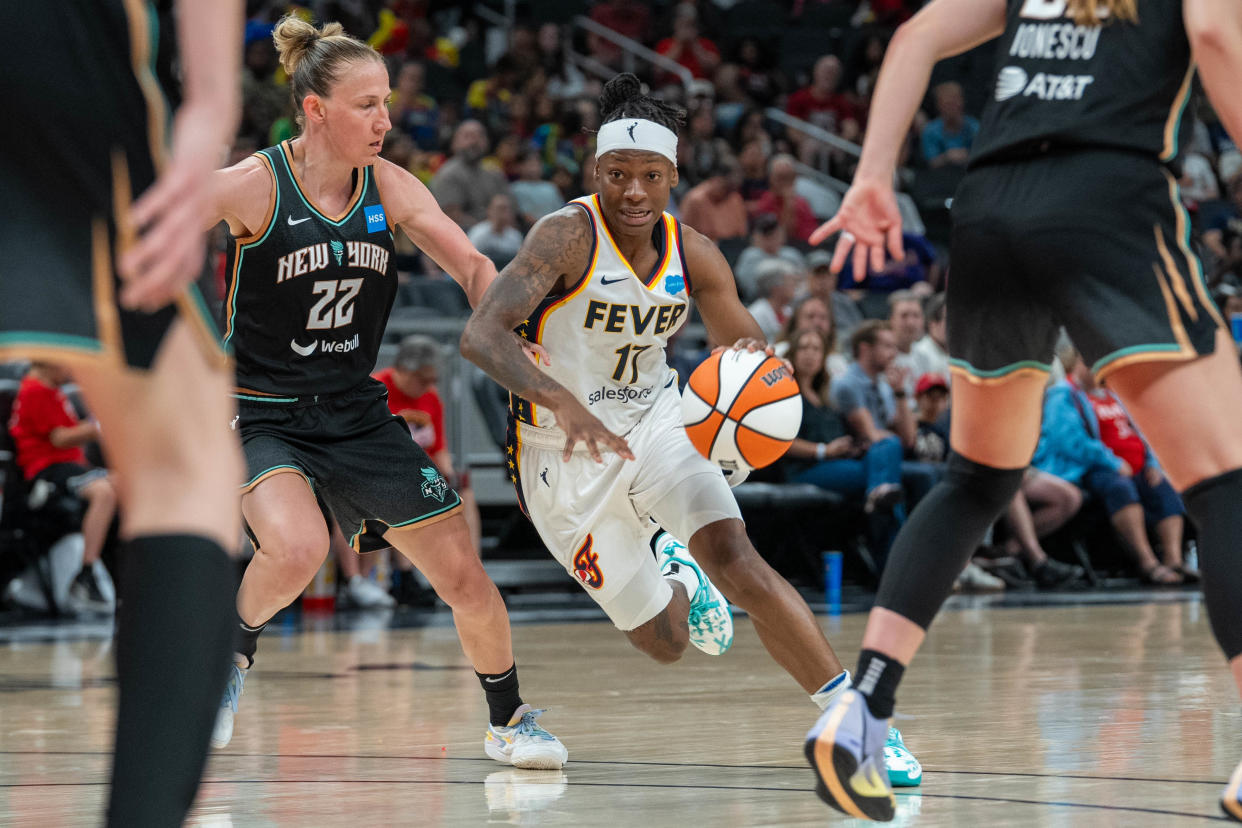 Indiana Fever guard Erica Wheeler (17) weaves through New York Liberty defenders during their game Wednesday, July 12, 2023 in Gainbridge Fieldhouse in Indianapolis.