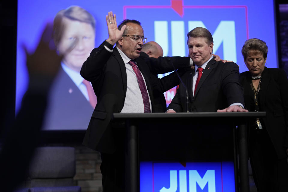 Pastor Jimmy Morales, left, prays over Jim Marchant at an event to announce Marchant's candidacy for the U.S Senate seat in Nevada, Tuesday, May 2, 2023, in Las Vegas. (AP Photo/John Locher)