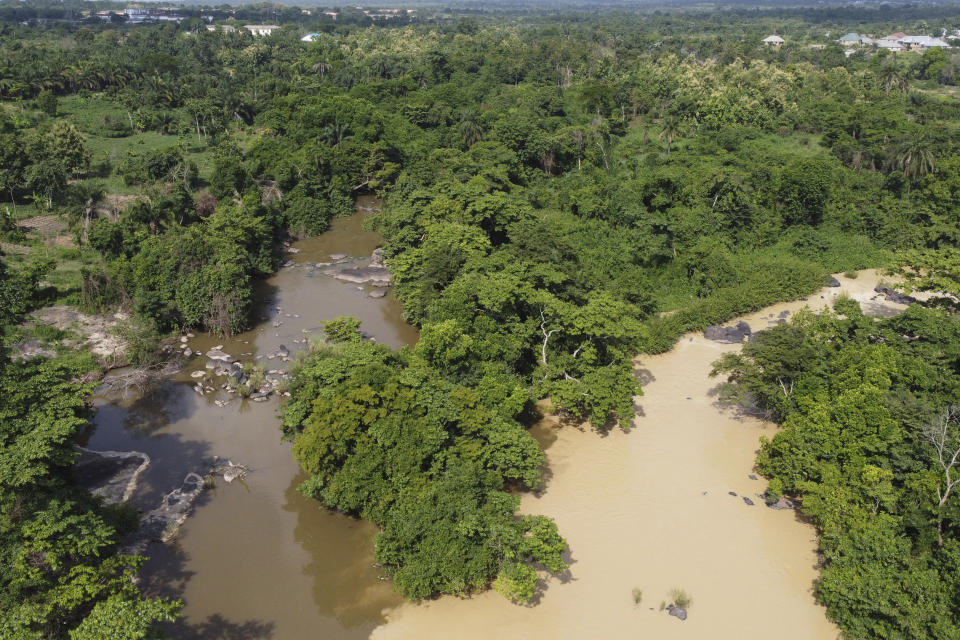 The Osun River flows through the forest of the Osun-Osogbo Sacred Grove, designated a UNESCO World Heritage Site in 2005, in Osogbo, Nigeria, on Monday, May 30, 2022. The nonprofit advocacy group Urban Alert conducted a series of tests on the Osun in 2021 and found it to be “heavily contaminated.” The report found lead and mercury levels in the water at the grove that were, respectively, 1,000% and 2,000% above what's permissible under the Nigerian Industrial Standard. (AP Photo/Lekan Oyekanmi)