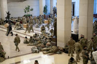 WASHINGTON, DC - JANUARY 13: Members of the National Guard rest in the Visitor Center of the U.S. Capitol on January 13, 2021 in Washington, DC. Security has been increased throughout Washington following the breach of the U.S. Capitol last Wednesday, and leading up to the Presidential inauguration. (Photo by Stefani Reynolds/Getty Images)