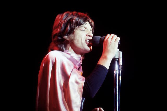 <p>Jeff Hochberg/Getty</p> Mick Jagger performs at Altamont in 1969.