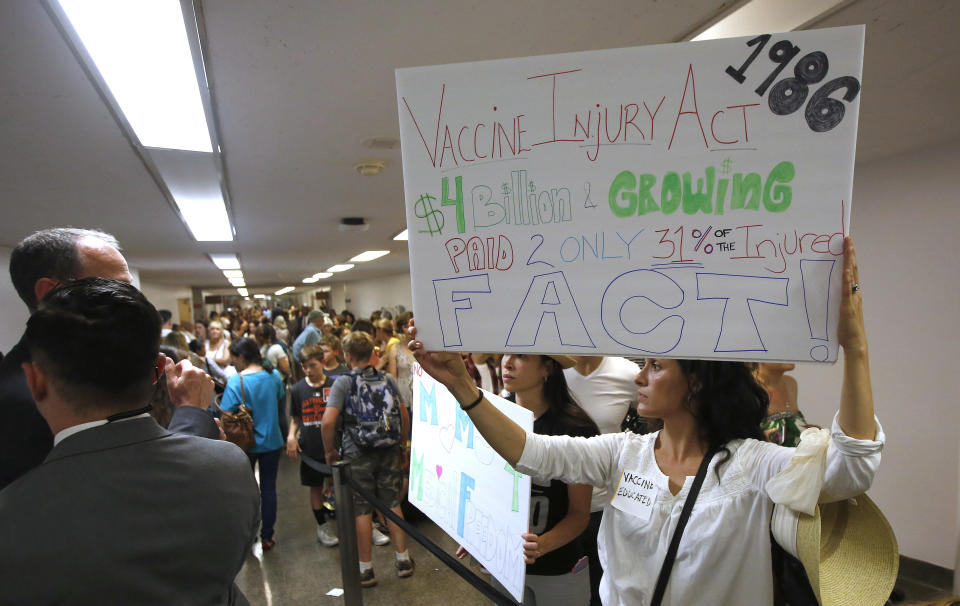 Ruth Mirelly Osuna, right, of Los Angeles, traveled to the Capitol to join hundreds of others to oppose a proposal to give state public health officials instead of local doctors the power to decide which children can skip their shots before attending school, at the Capitol Wednesday, April 24, 2019, in Sacramento, Calif. State Sen. Richard Pan, D-Sacramento, a pediatrician, the bills author, told members of the Senate Health Committee that his legislation would give state health officials the tools they need to prevent outbreaks of vaccine-preventable diseases like the measles. (AP Photo/Rich Pedroncelli)