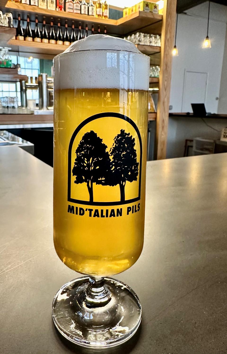 Enjoy a smooth Mid 'Talian Pils with a slice at Woodshop by UnHitched Brewing Company at the Fourth Street Collective.