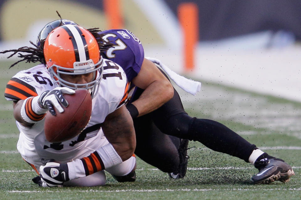 Josh Cribbs #16 of the Cleveland Browns is tackled by Chris Carr #25 of the Baltimore Ravens after catching a pass during the second half at M&T Bank Stadium on December 24, 2011 in Baltimore, Maryland. (Photo by Rob Carr/Getty Images)