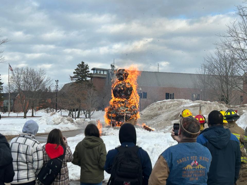 The burning snowman, made of a wire frame and paper products, burns away to symbolize the beginning of spring on March 20, 2023.