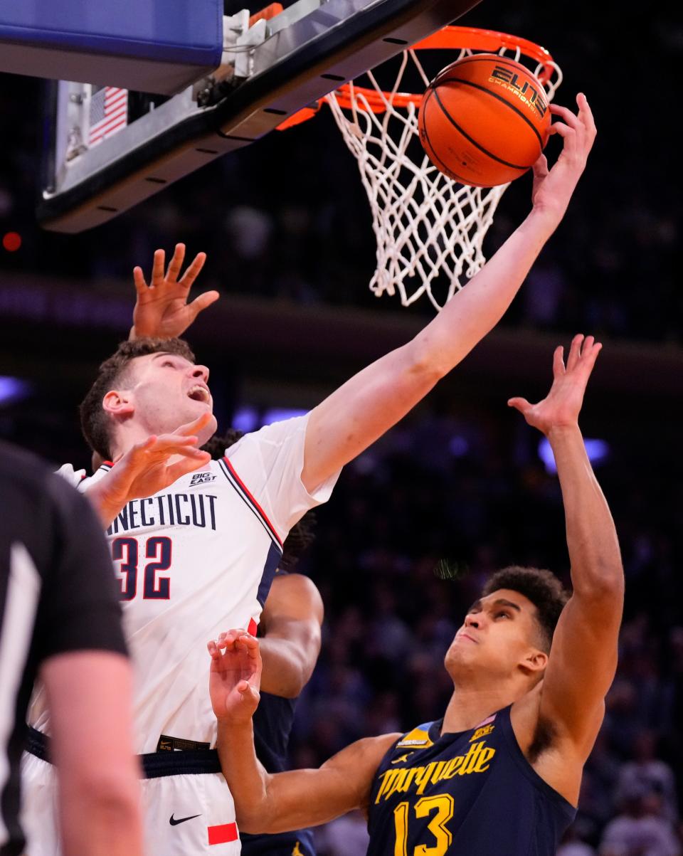 Connecticut Huskies center Donovan Clingan (32) shoots over Marquette Golden Eagles forward Oso Ighodaro (13) during the first half at Madison Square Garden on March 16, 2024.