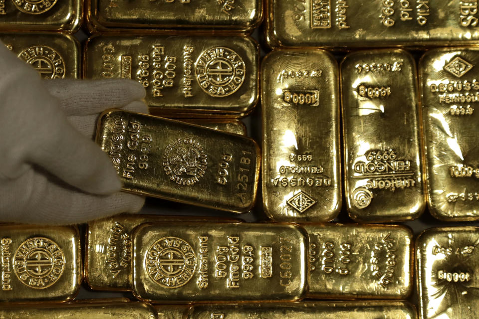 Employees of ProAurum gold house prepares 0.5 Kg gold bars of 999.9 purity in the safe deposit boxes room in Munich, Germany, Thursday, Dec. 13, 2018. (AP Photo/Matthias Schrader)