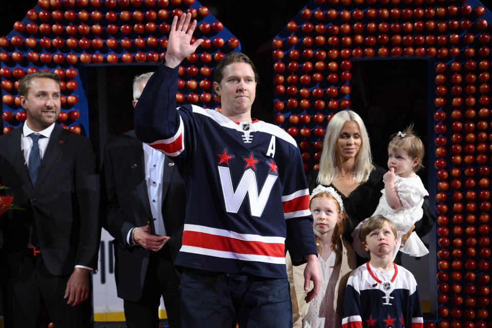 Washington Capitals center Nicklas Backstrom waves the the crowd at a ceremony to honor him for recording his 1,000th NHL point before an NHL hockey game against the New Jersey Devils, Saturday, March 26, 2022, in Washington. (AP Photo/Nick Wass)