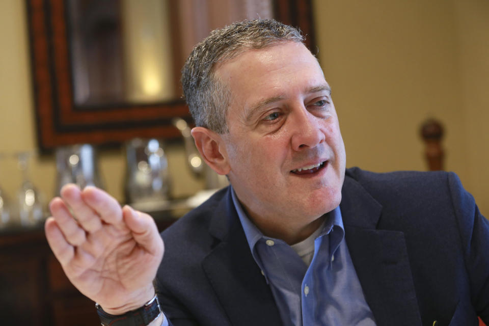 In this Nov. 19, 2019, photo James Bullard, president of the St. Louis Federal Reserve Bank, gestures during an interview in Richmond, Va. (AP Photo/Steve Helber)