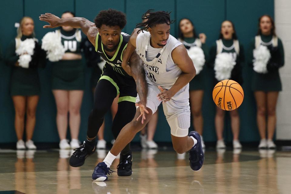 Jordan Davis of Jacksonville University (11) goes after a loose ball against Jarius Hicklen of the University of North Florida during their game on Feb. 2 at JU's Swisher Gym.