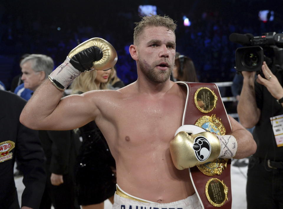 FILE - In this Dec. 16, 2017, file photo, Billy Joe Saunders, of Britain, celebrates his win over David Lemieux, of Canada, to retain the WBO middleweight boxing title in Laval, Quebec. Saunders had his boxing license suspended Monday, March 30, 2020, after publishing a social media video in which he appeared to condone domestic violence amid the coronavirus outbreak. He has apologized for his remarks, saying: “It was a silly mistake but I didn't mean to cause any harm to anyone and I certainly wouldn't promote domestic violence.”(Ryan Remiorz/The Canadian Press via AP)