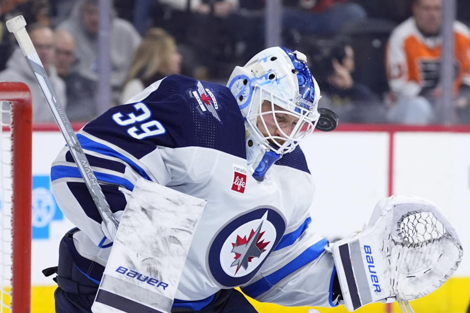 Winnipeg Jets' Laurent Brossoit blocks a shot during the second period of an NHL hockey game against the Philadelphia Flyers, Thursday, Feb. 8, 2024, in Philadelphia. (AP Photo/Matt Slocum)