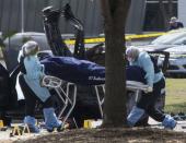 The bodies of two gunmen are removed from behind a car during an investigation by the FBI and local police in Garland, Texas May 4, 2015. REUTERS/Laura Buckman