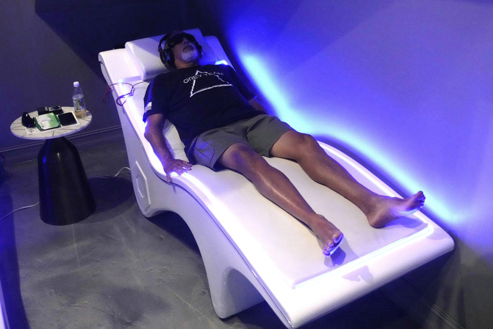 Veteran Steve Anton lies on a Stress Reduction bed at the Grey Team veterans center, Wednesday, May 17, 2023, in Boca Raton, Fla. The center is helping veterans with post-traumatic stress disorder and other mental and physical ailments get back into the civilian world. (AP Photo/Lynne Sladky)