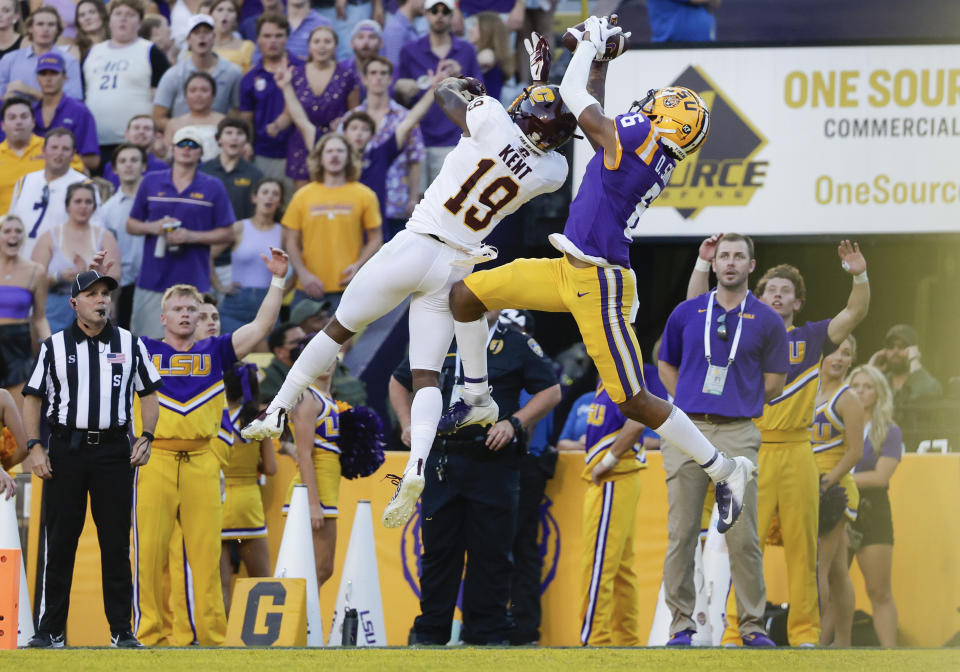 LSU wide receiver Deion Smith (6) catches a pass for a touchdown next to Central Michigan defensive back Donte Kent (19) during the first quarter of an NCAA college football game in Baton Rouge, La,. Saturday, Sept. 18, 2021. (AP Photo/Derick Hingle)
