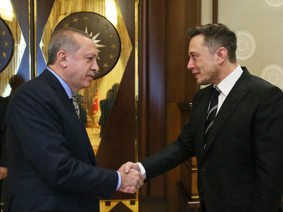Turkey's President Recep Tayyip Erdogan, left, shakes hands with Elon Musk, right, Tesla and SpaceX CEO, prior to their meeting in Ankara, Turkey, Wednesday, Nov. 8, 2017. Erdogan's office did not immediately provide details on the meeting, however it comes days after a consortium of five Turkish businesses, including mobile phone operator Turkcell, launched a joint venture to design and produce a Turkish-made car, a joint venture was launched under Erdogan's urging. (Pool Photo via AP)