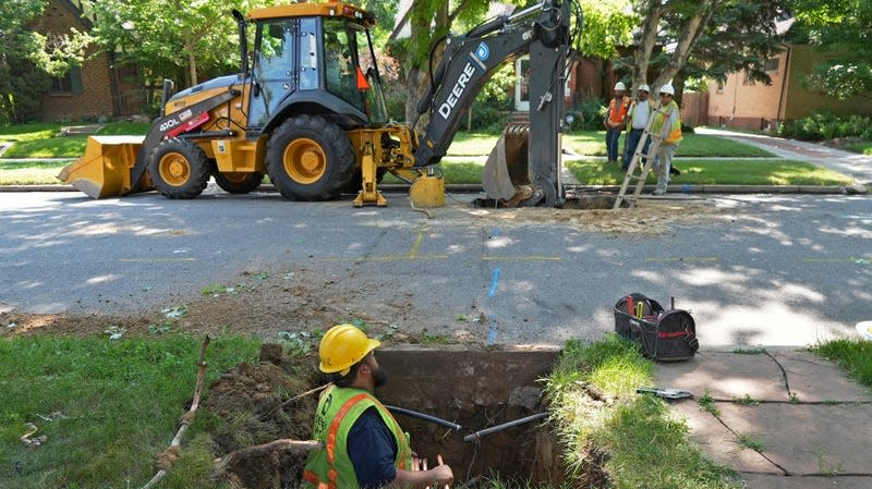 A Denver Water crew works to replace a lead water service line installed in 1927 with a new copper one at a private home on June 17, 2021, in Denver.