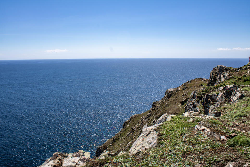 Hiking the Beara cliffs on a beautiful day is an unforgettable experience. The Beara Peninsula, located in West Cork, Ireland, is a hidden gem of stunning natural beauty. The cliffs offer panoramic views of the Atlantic Ocean, with rugged terrain and lush greenery as far as the eye can see.

The hike is not for the faint of heart, as the terrain can be challenging and the cliffs steep. However, the reward of reaching the top is well worth the effort. The views are simply breathtaking, with the sea stretching out before you as far as the eye can see.

On a clear day, the water is a brilliant shade of blue, with waves crashing against the rocks far below. The sound of the ocean is both calming and exhilarating, making it easy to lose yourself in the moment and forget about the world outside.

As you hike along the cliffs, you'll pass by a variety of flora and fauna, from wildflowers and ferns to seabirds soaring overhead. The terrain is ever-changing, with rocky outcroppings, lush valleys, and narrow paths that wind their way along the edge of the cliffs.

Overall, hiking the Beara cliffs is an unforgettable experience that offers both physical and mental challenges, as well as stunning views of the sea and surrounding landscape. It's the perfect way to get away from the hustle and bustle of daily life and connect with nature in all its raw and rugged beauty.