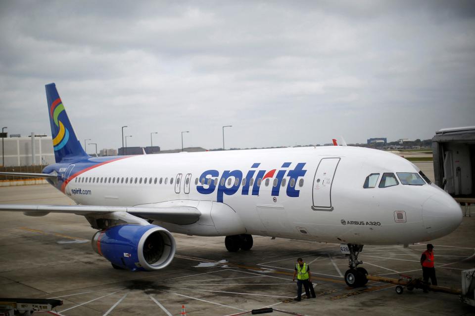 A plane with the Spirit Airlines logo printed in blue font.