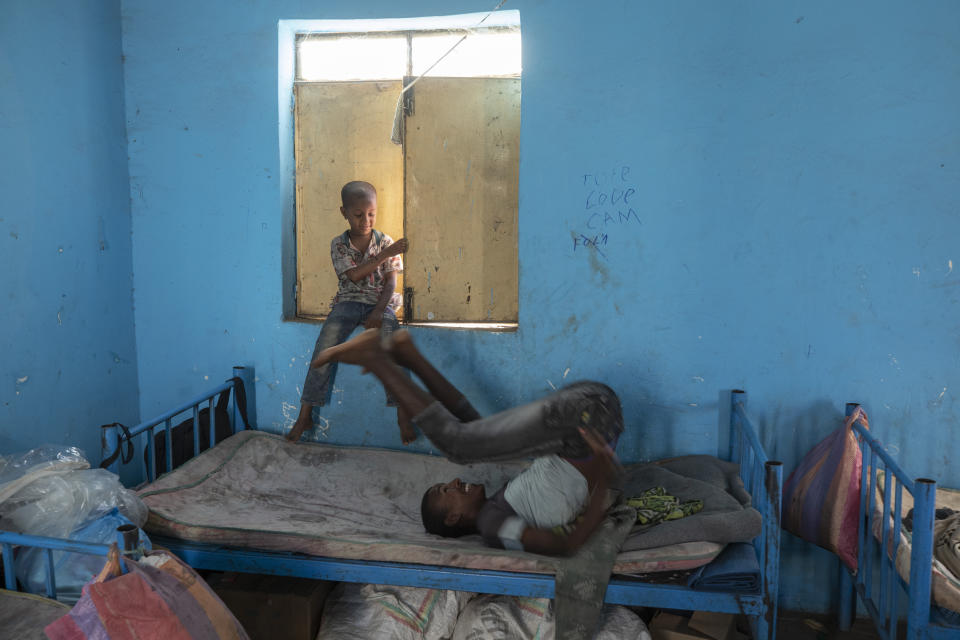 Tigrayan 5-year-old refugee Micheale Gebremariam, left, plays with a friend inside his family's shelter in Hamdayet, eastern Sudan, near the border with Ethiopia, on March 21, 2021. (AP Photo/Nariman El-Mofty)