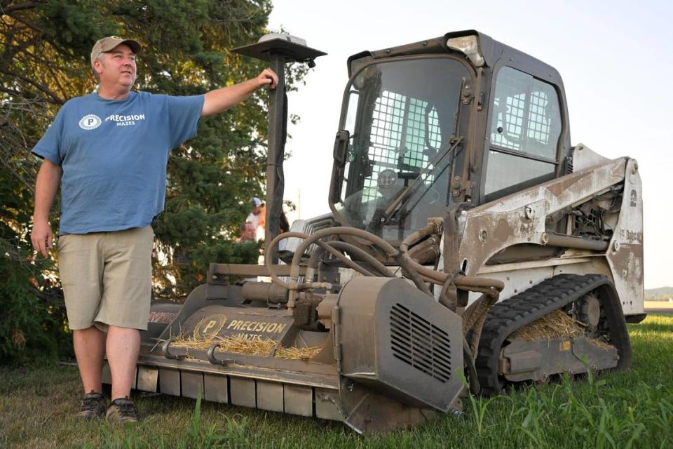 Rob Stouffer of Precision Mazes, based in Lee’s Summit, uses a bobcat with a front-mounted cutting device to create crop murals, including a welcome message to Taylor Swift on Monday, July 3, 2023, in a field in Orrick, Missouri.