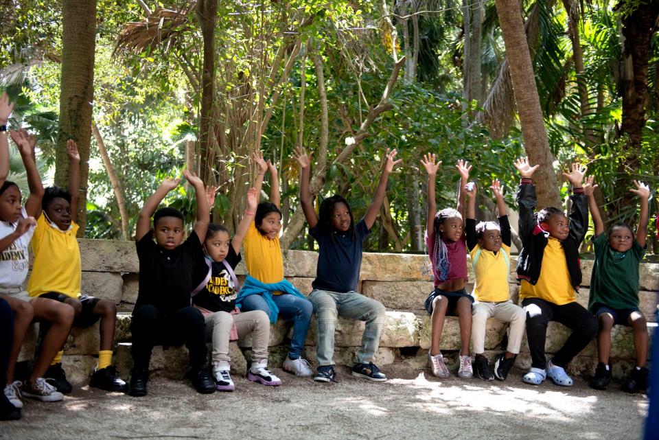 Students from Glades Academy listen to Bryan Galvin representing of Friends of Palm Beach discusses plastic on Florida beaches during the Earth Day celebration April 21 at the Ann Norton Sculpture Gardens. 'An Evening of Great Expectations,' which benefits the academy and Everglades Prep, will be held Jan. 12.