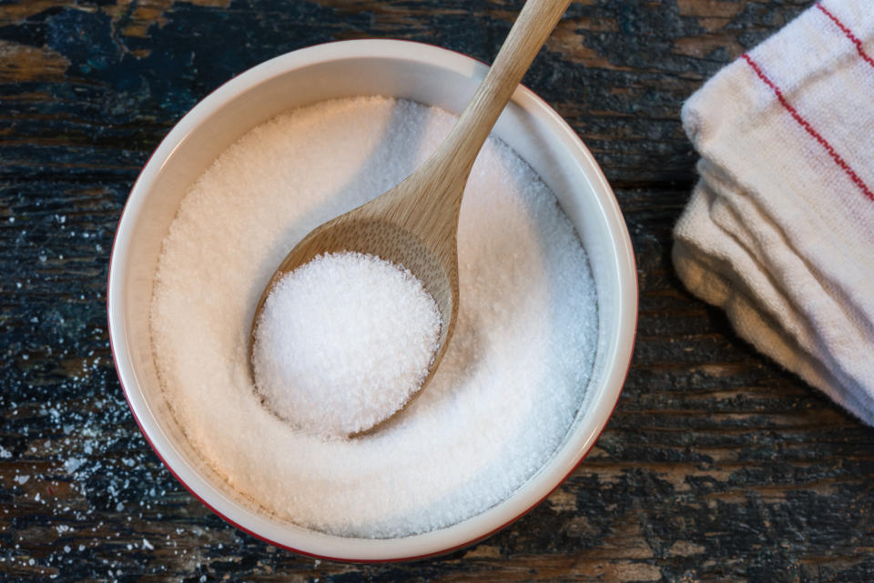 A bowl of salt with a spoon.