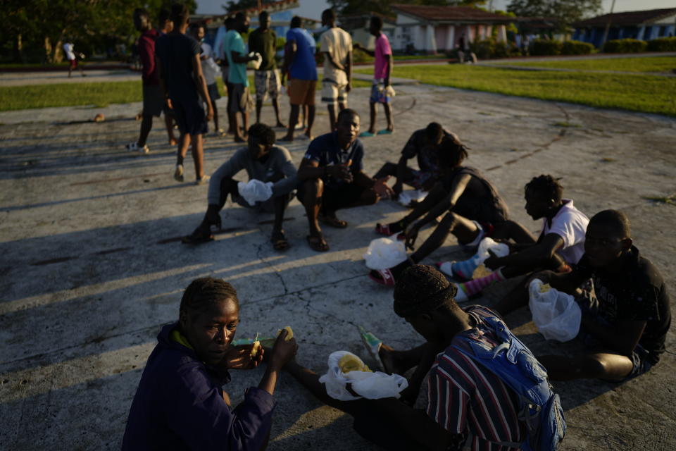 Haitian migrants eat at a tourist campground in Sierra Morena, in the Villa Clara province of Cuba, Wednesday, May 25, 2022. A vessel carrying more than 800 Haitians trying to reach the United States wound up instead on the coast of central Cuba, government news media said Wednesday. (AP Photo Ramon Espinosa)