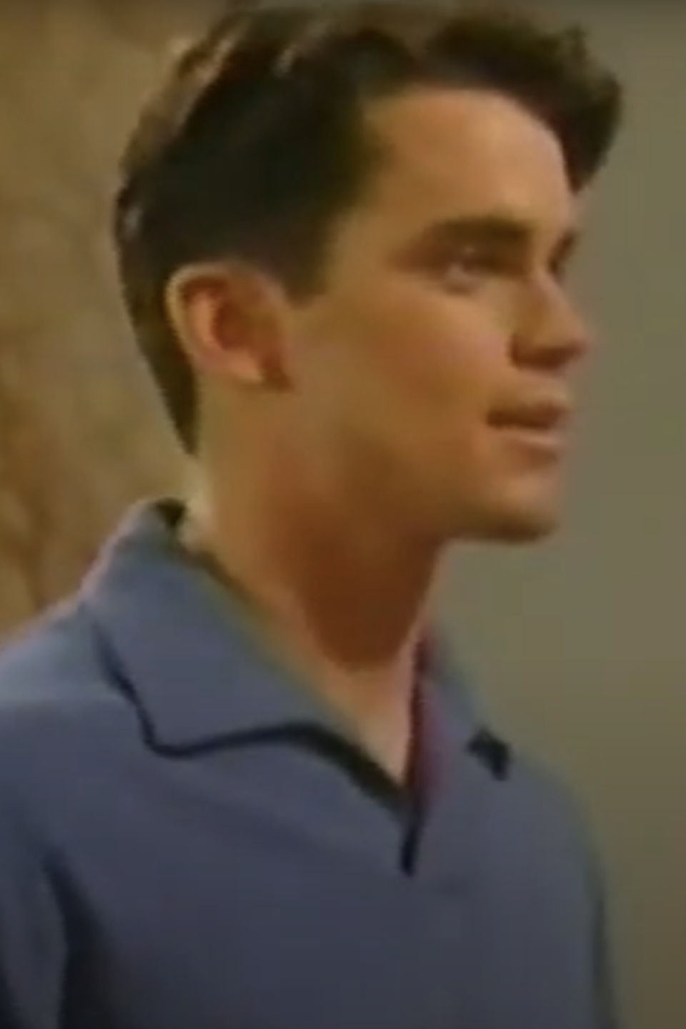 Matt Bomer, in a casual shirt, appears in a scene from a TV show