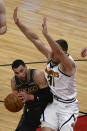 Chicago Bulls guard Zach LaVine, left, drives to the basket against Denver Nuggets forward Vlatko Cancar (31) during the first half of an NBA basketball game Monday, March 1, 2021, in Chicago. (AP Photo/Matt Marton)