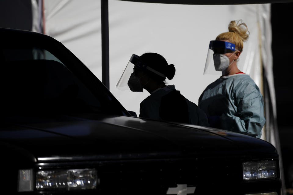 Healthcare workers test patients in their cars at a drive-thru coronavirus testing site run by the University of Nevada Las Vegas School of Medicine and the Nevada National Guard, July 10, 2020, in Las Vegas. / Credit: John Locher/AP