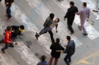 RNPS - PICTURES OF THE YEAR 2013 - ATTENTION EDITORS - VISUAL COVERAGE OF SCENES OF INJURY OR DEATH Protesters flee from tear gas fired by riot police during clashes after protesters removed a concrete barrier at Qasr al-Aini Street near Tahrir Square in Cairo January 24, 2013. REUTERS/Mohamed Abd El Ghany (EGYPT - Tags: CIVIL UNREST POLITICS TPX)