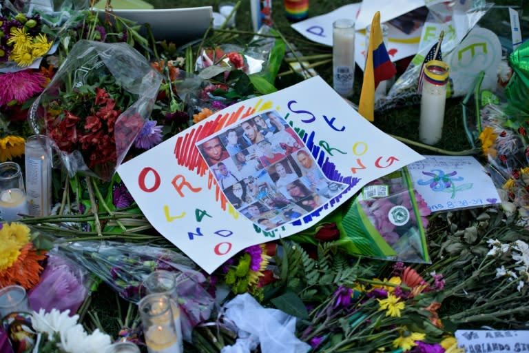 Photos and flowers at a memorial to honor the Pulse nightclub mass shooting victims, pm June 14, 2016 in Orlando, Florida