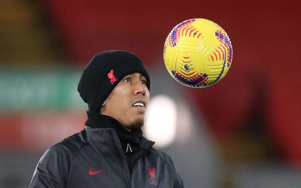 Roberto Firmino warms up at Anfield - AFP